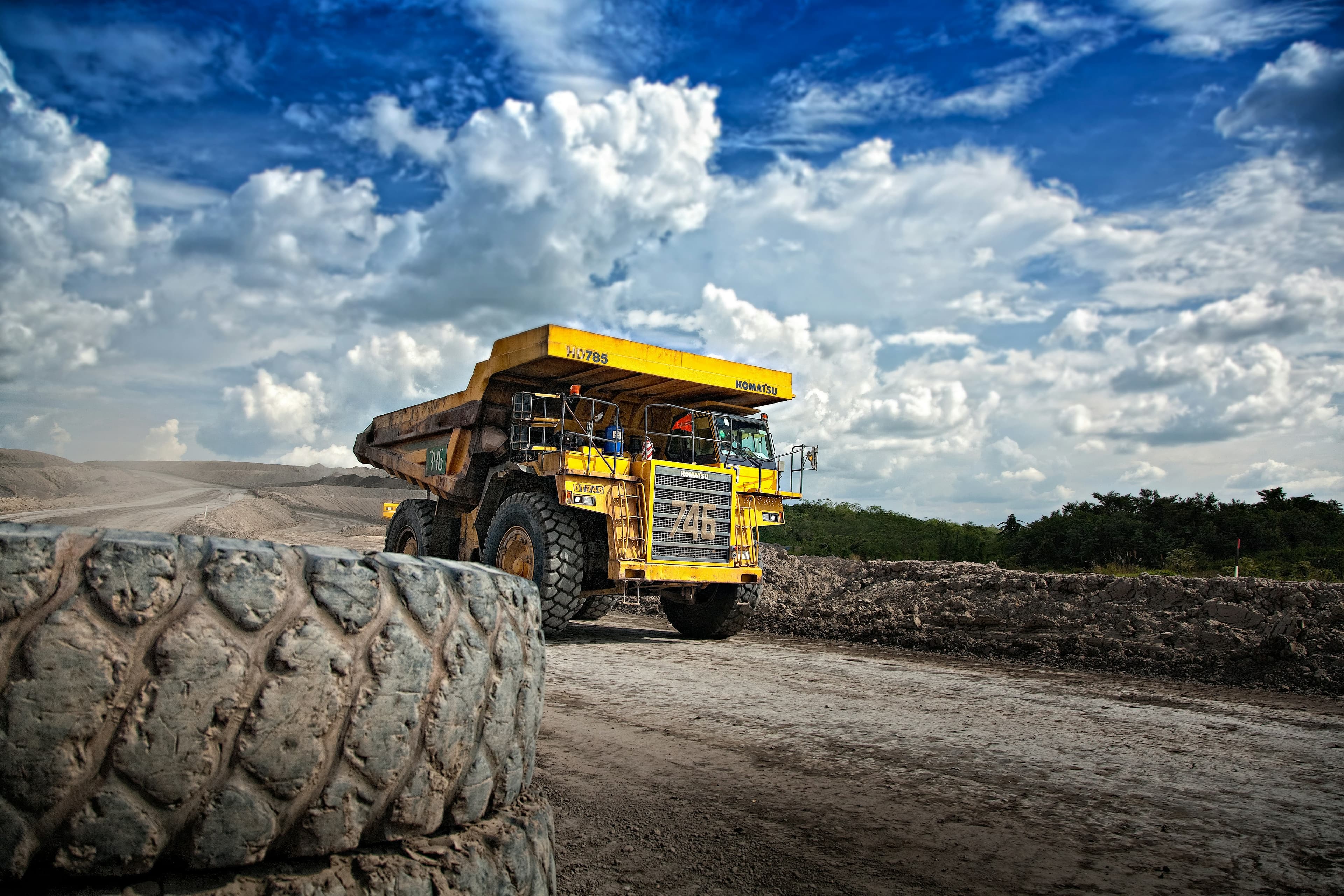 Yellow mining dump trucks working in an open pit mine